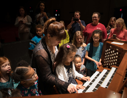 Thévenot with children at the Aeolian-Skinner console