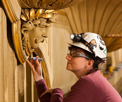 EverGreene conservator Brooke Russell with carved image of James Bayard Woodford
