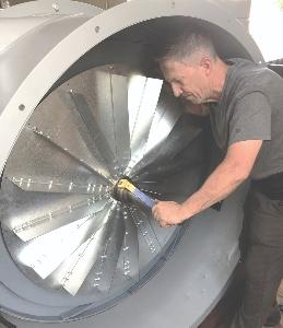 Joe Sloane installing new fans in a large organ blower