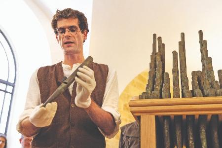 David Catalunya carefully presents a pipe from the Organ of Bethlehem