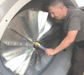 Joe Sloane installing new fans in a large organ blower